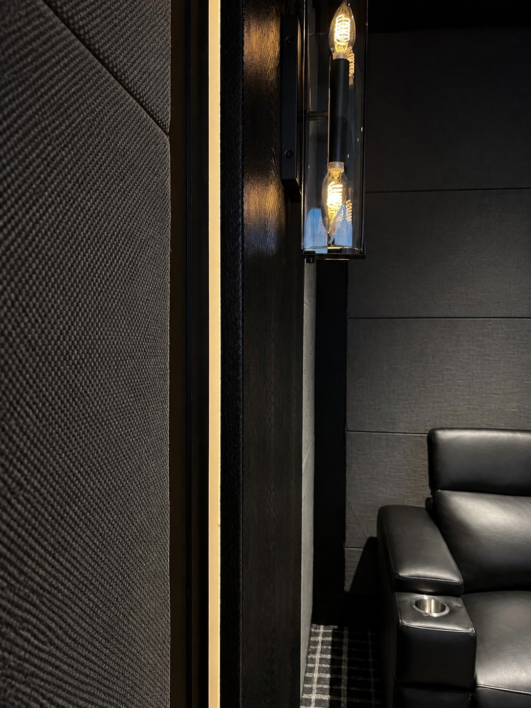 Acoustic panel, linear lighting, sconce, and leather seating detail