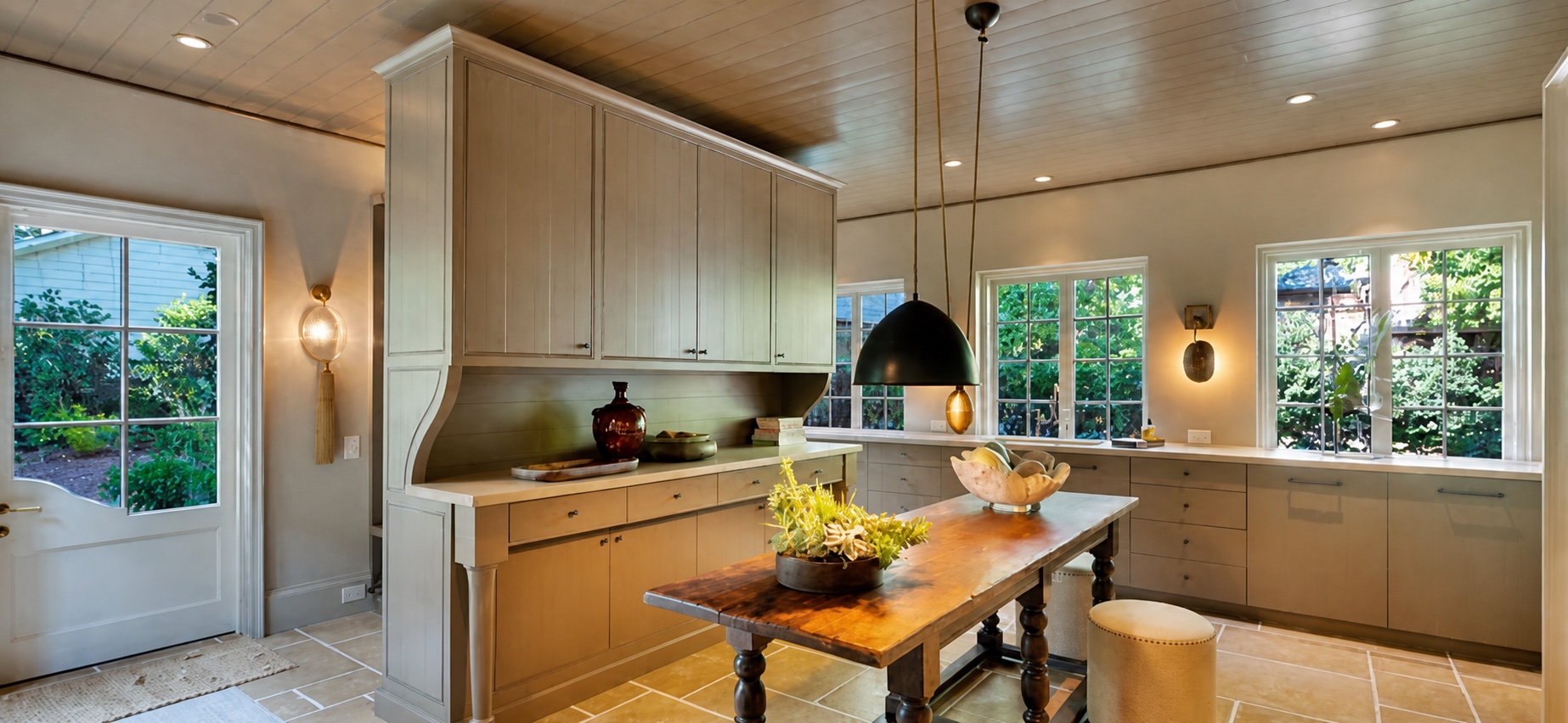 Secondary kitchen with layered lighting and tailored cabinetry