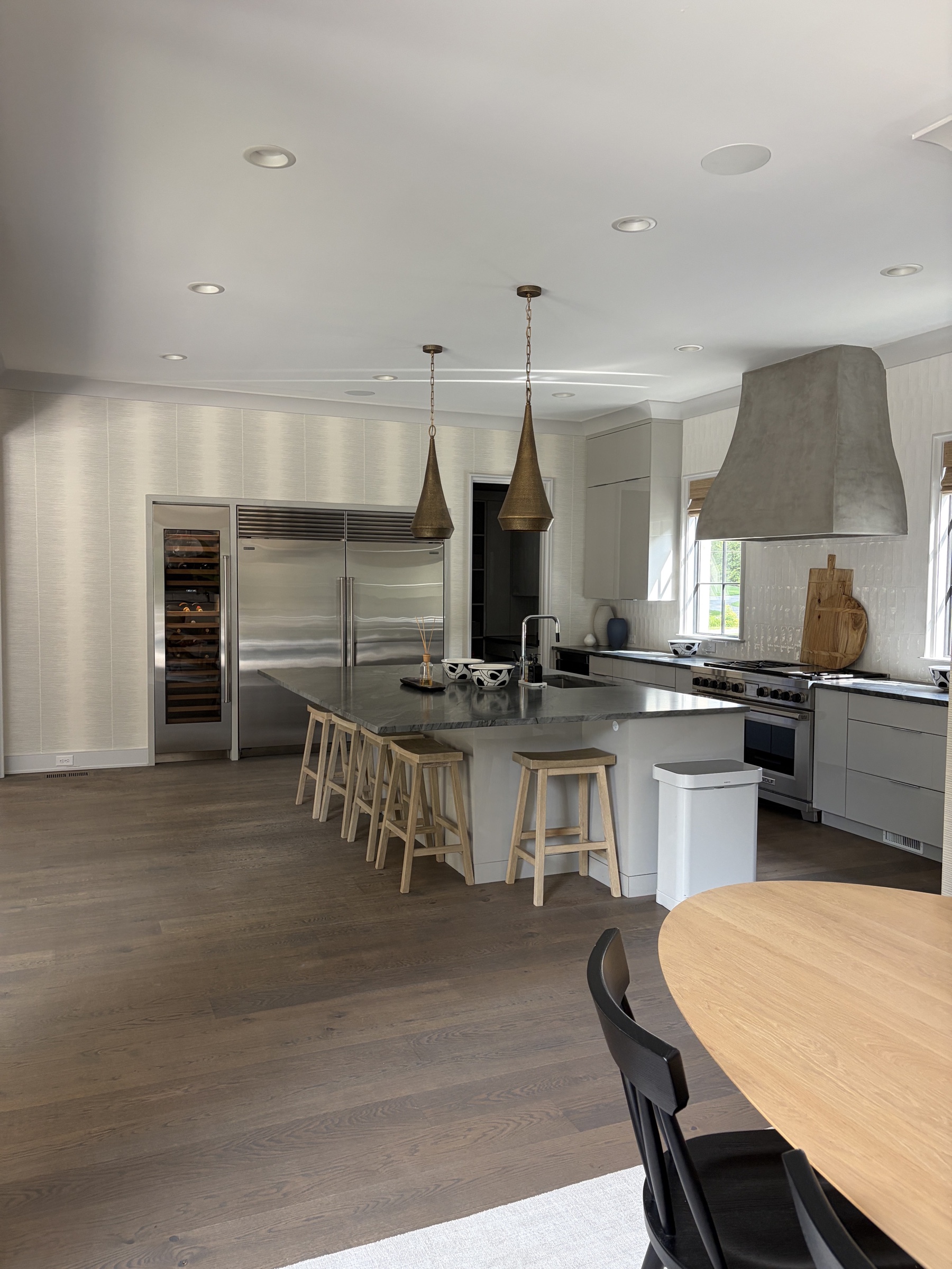Modern kitchen with sculptural pendant lights and in-ceiling speakers