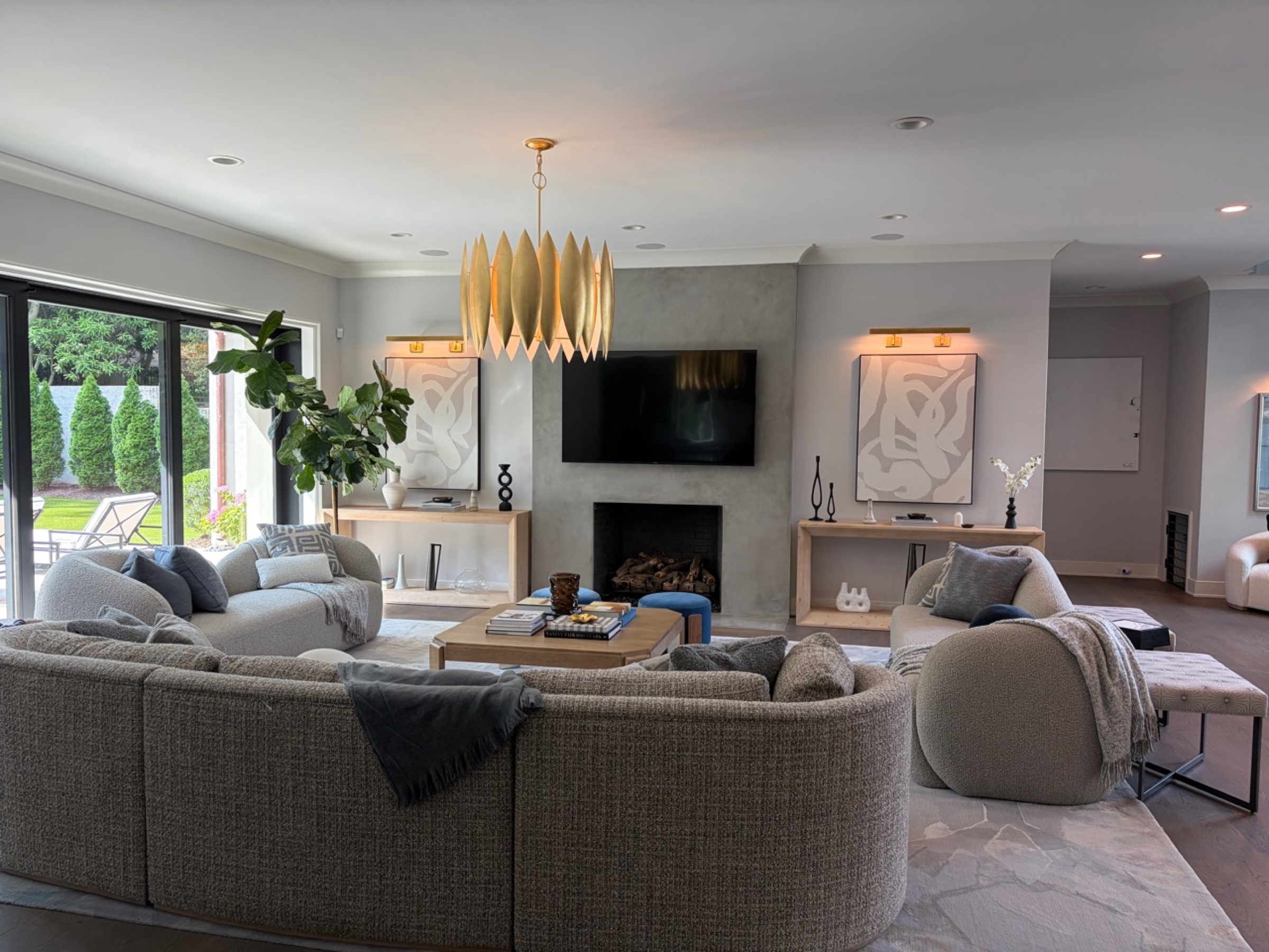 Living room with wall-mounted television and sliding doors to the pool