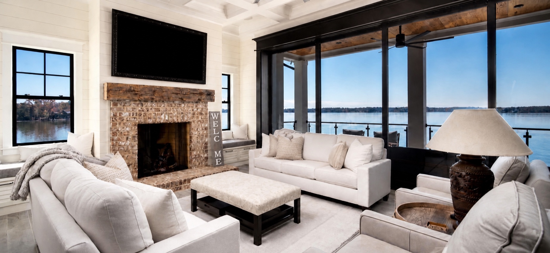 Living room with an integrated television and lake view