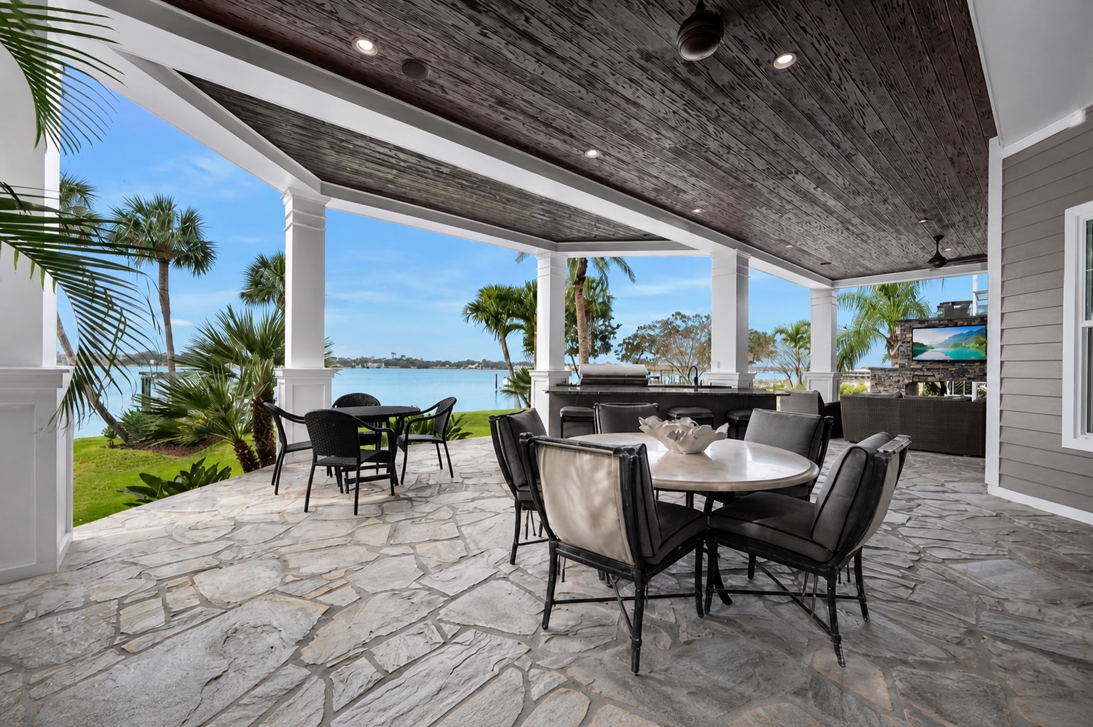 Covered outdoor dining area with waterfront views