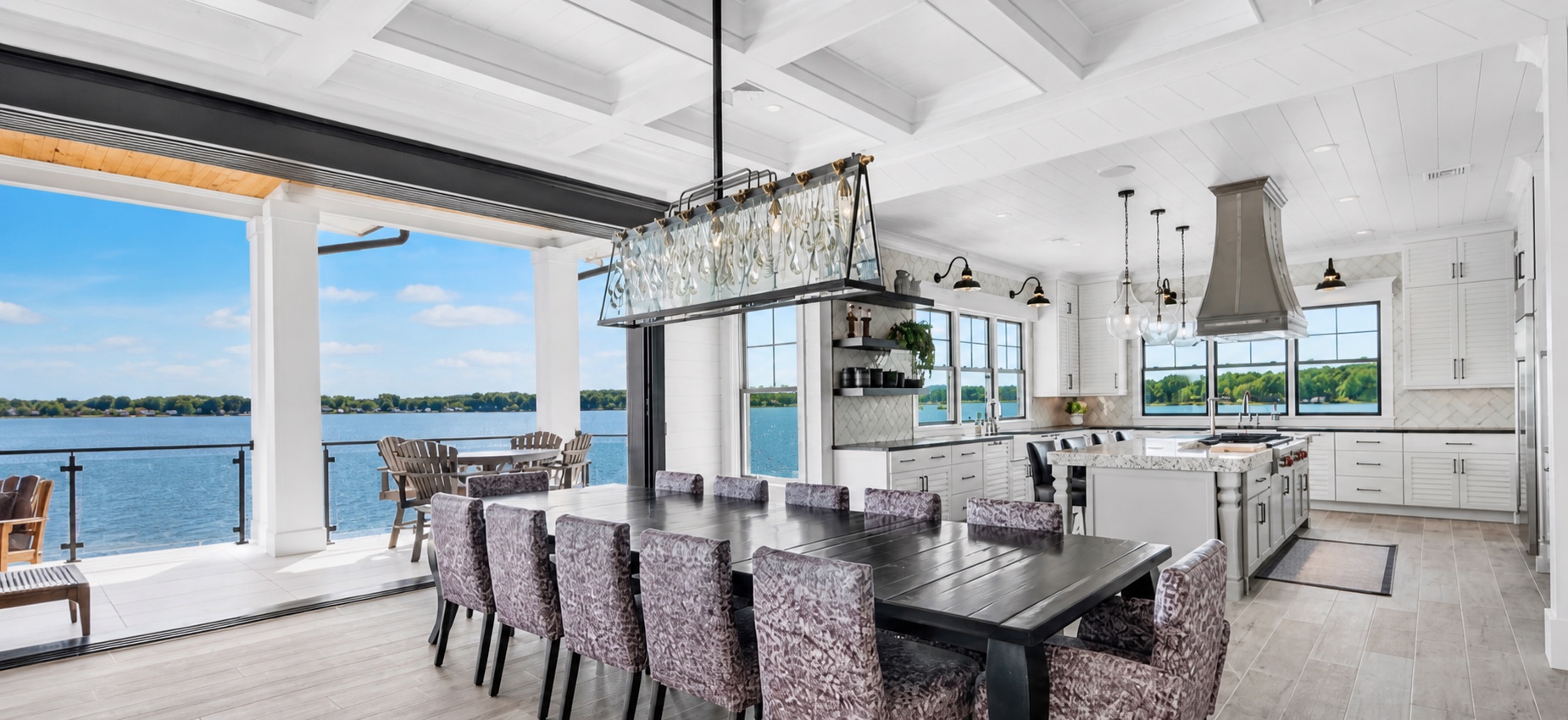 Lakefront dining room and kitchen opening directly to an outdoor terrace