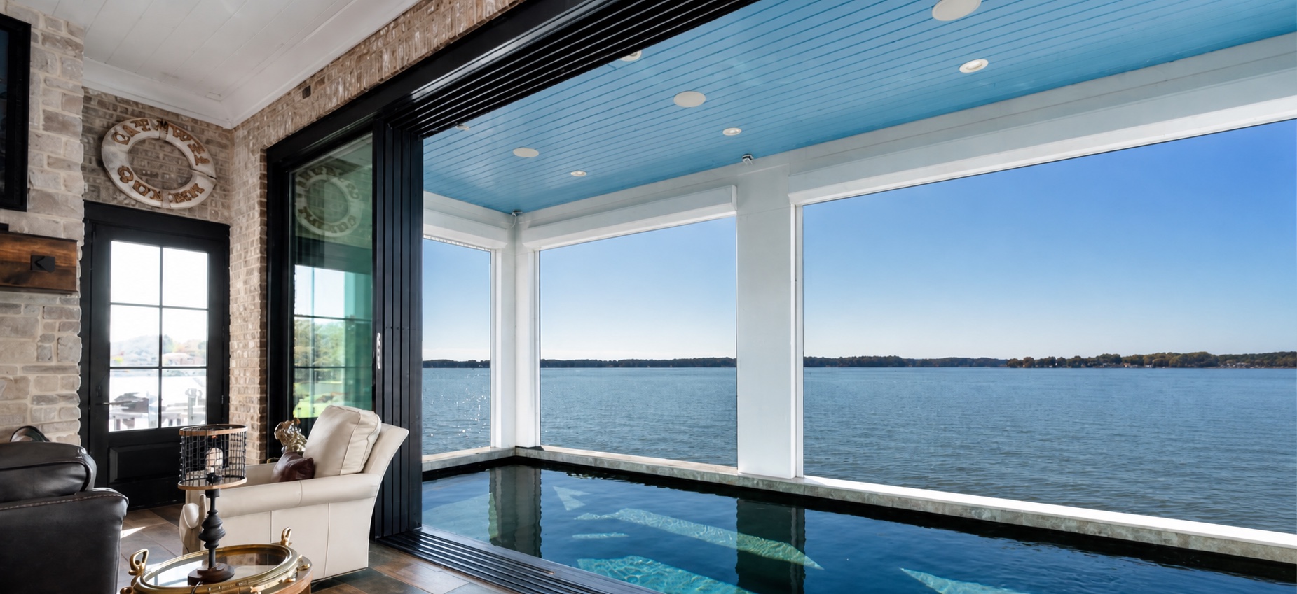 Completed indoor pool overlooking Lake Norman through an operable glass wall